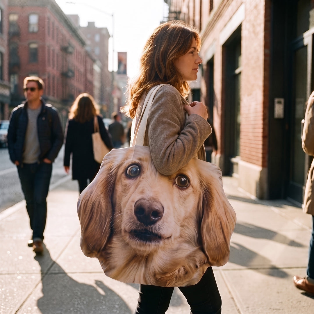 A canvas tote cut to the shape of a dachshund's head, carried on the shoulder in the street
