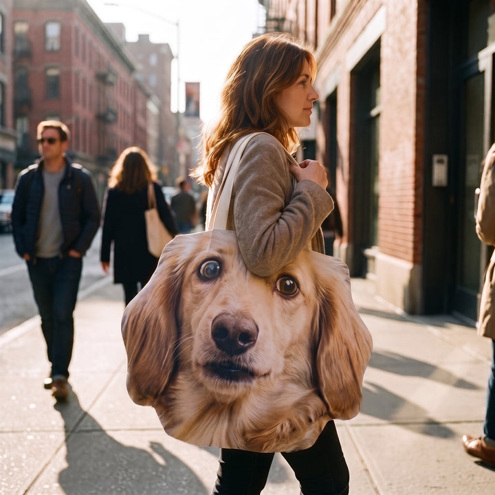 A canvas tote cut to the shape of a dachshund's head, carried on the shoulder in the street