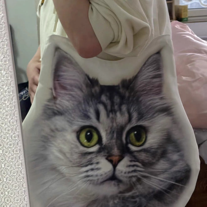 A cat-face tote carried on the shoulder