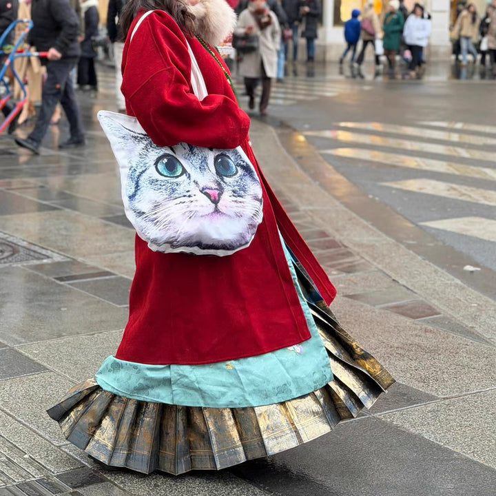 Customer carrying a cat face canvas tote bag on a city street