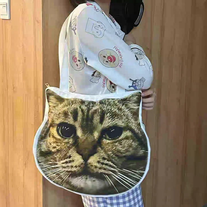 A cat-face tote held up beside a doorway