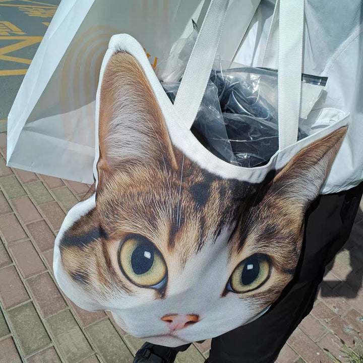 A cat-face tote carried outdoors with the shopping