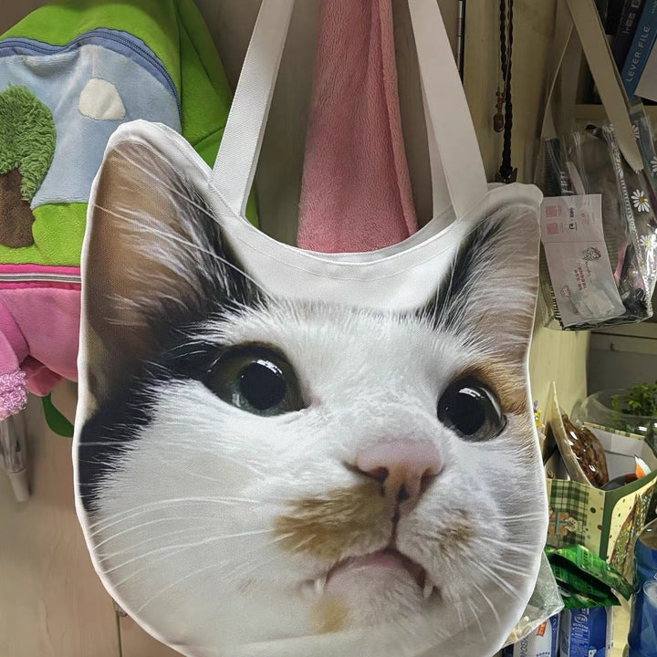 A cat-face tote hanging at home